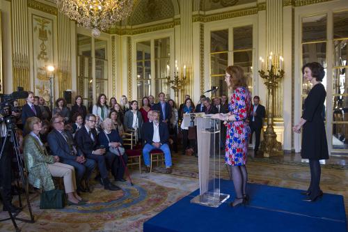 Pauline Baer de Perignon stands at a lectern in a room full of people