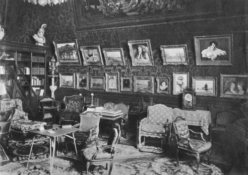 Black and white photo of a room in a 1930s Paris apartment crammed full of art and antiques