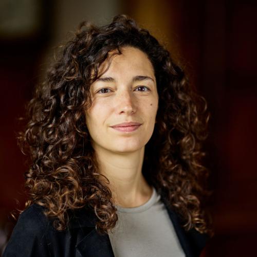 Silvia Butti, who has long dark brown curly hair