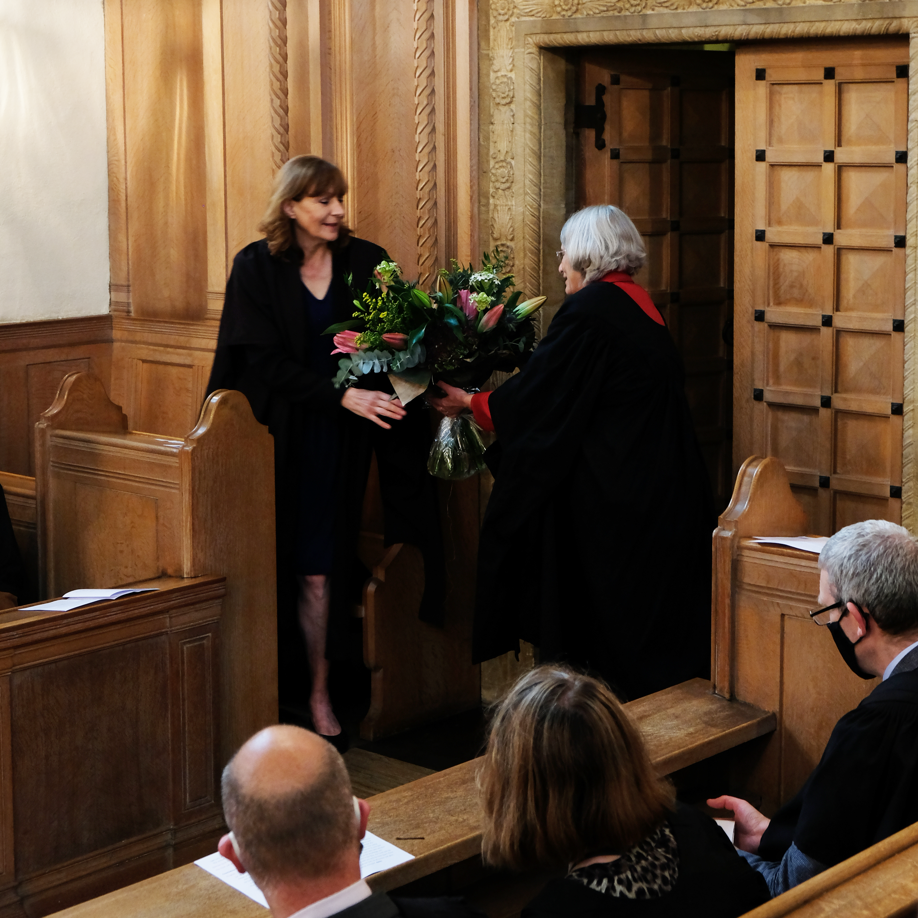 Professor Christine Gerrard being handed flowers in the LMH Chapel at the Principal's Inauguration
