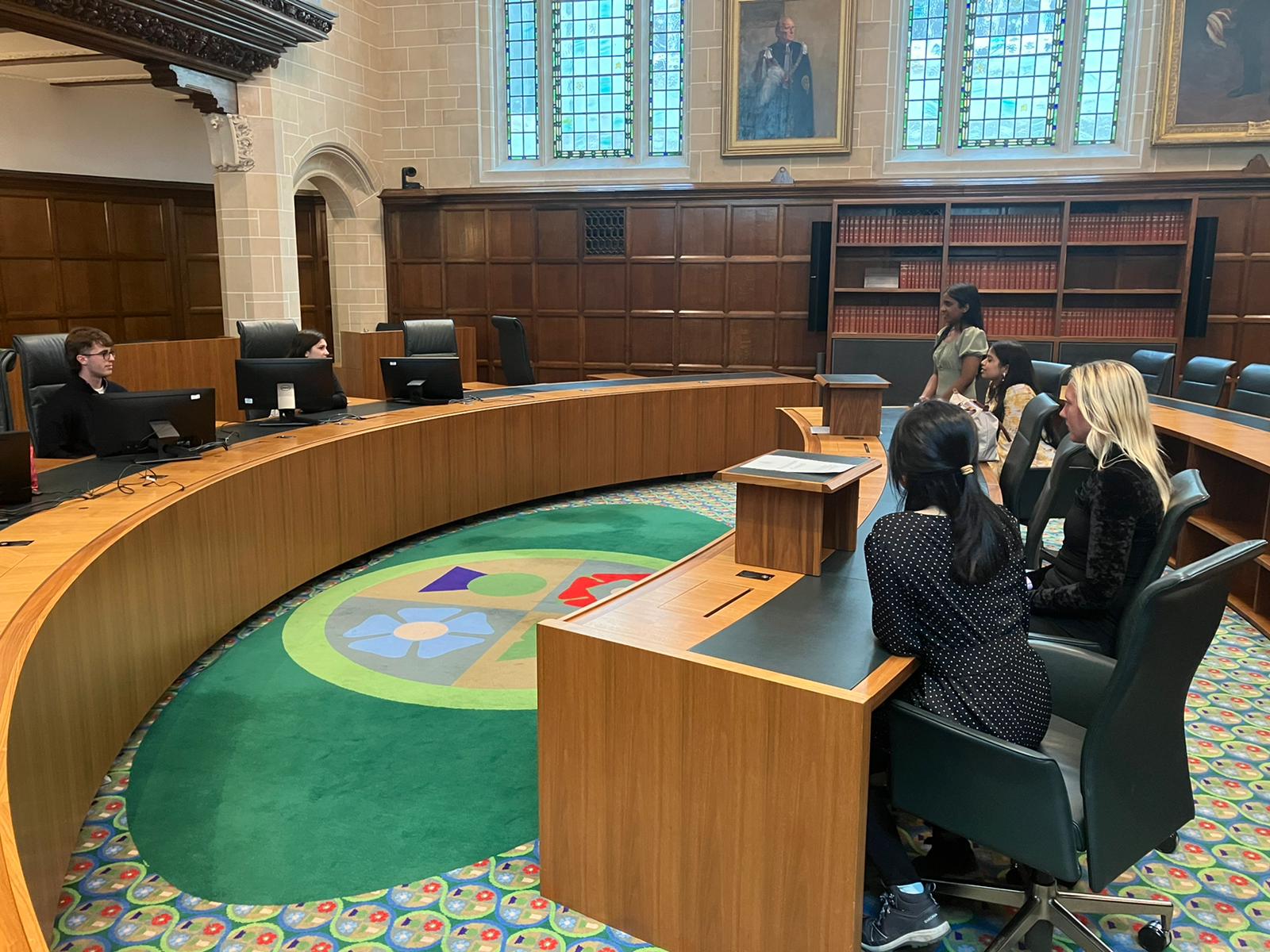 Photo of students sitting at desks at the UK High Court
