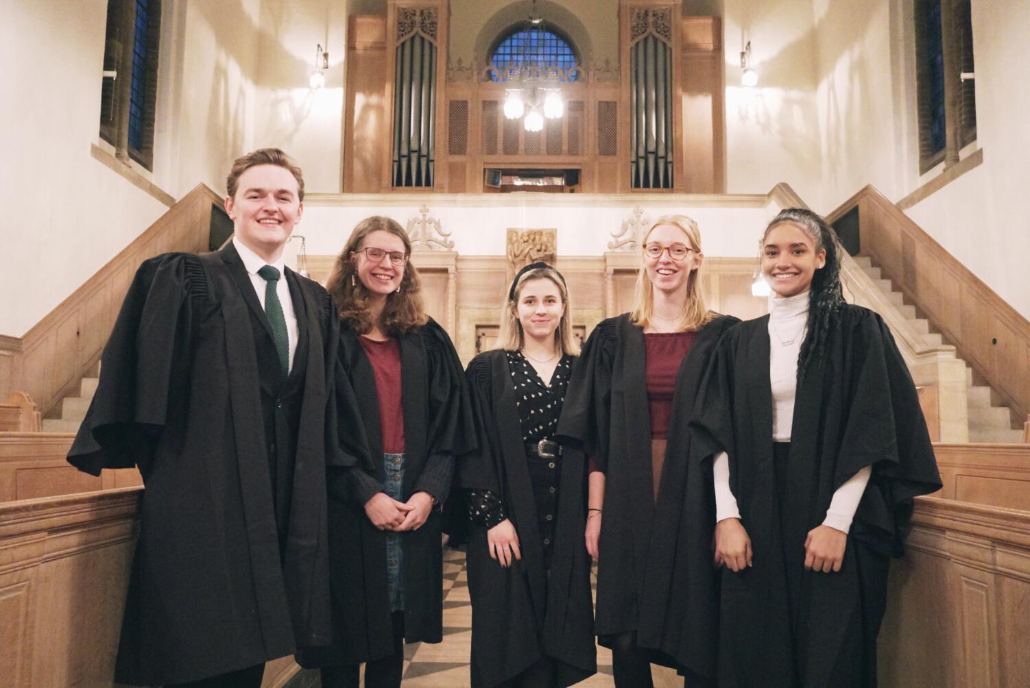 A picture of five LMH Choir Scholars standing together in the LMH Chapel.