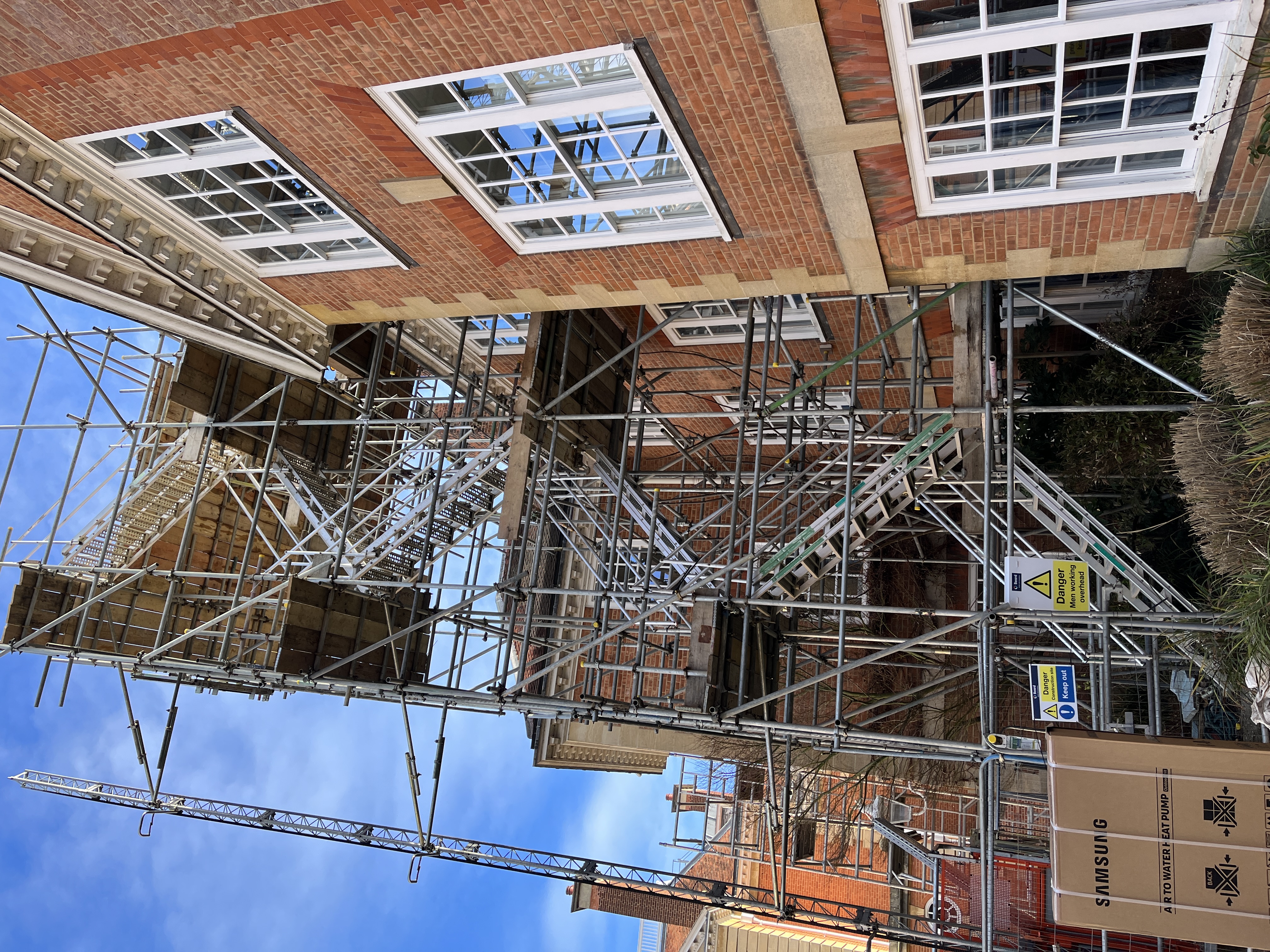 Photo of a red brick building with scaffolding