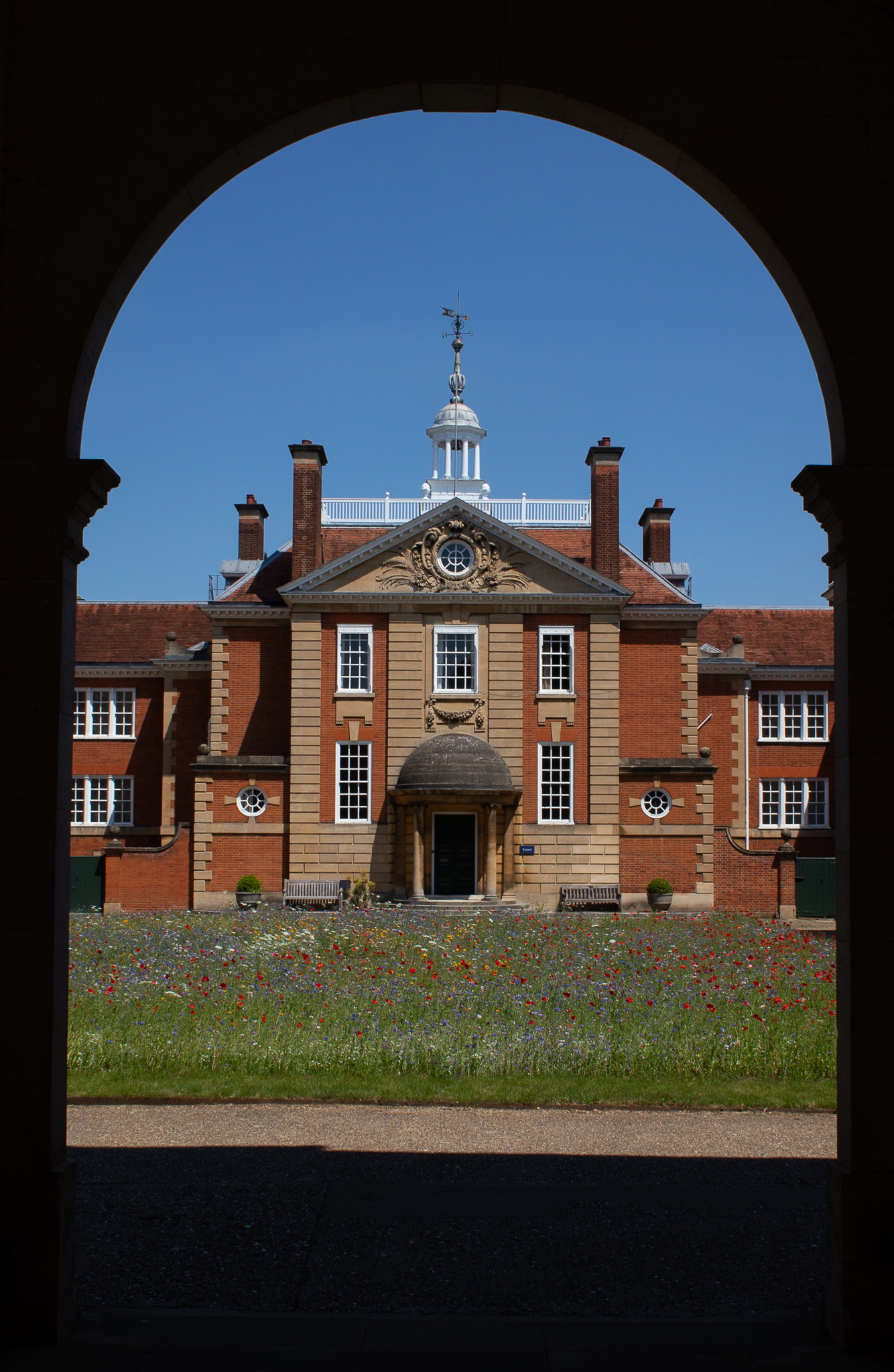 Photo by Michelle Mendieta Mean - View of Talbot Hall and flower meadow through the archway