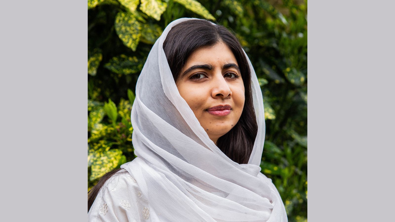Photo of Malala Yousafzai wearing a pale grey headscarf
