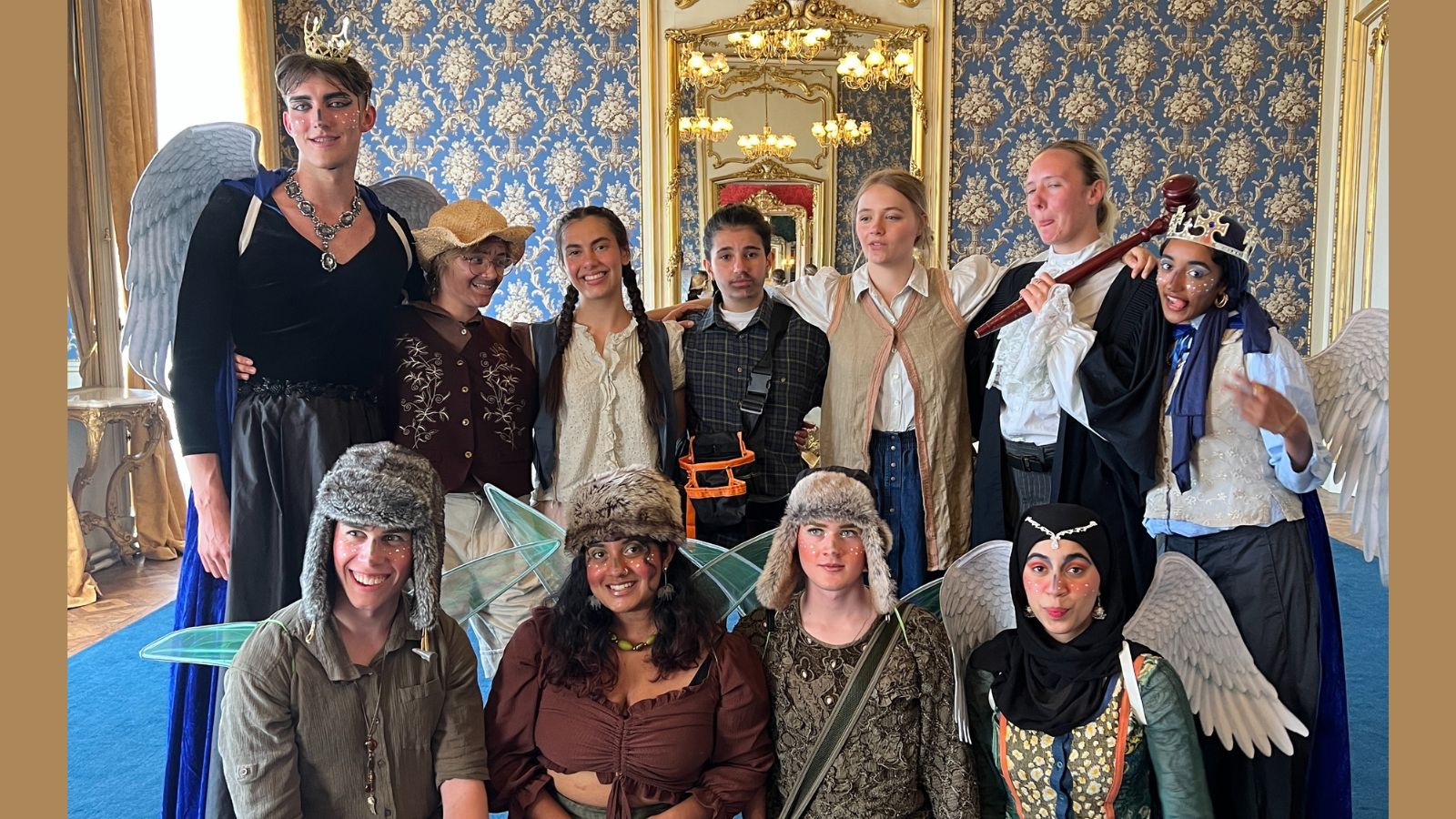 A photo of a group of students dressed in costumes to perform a play in a historic house