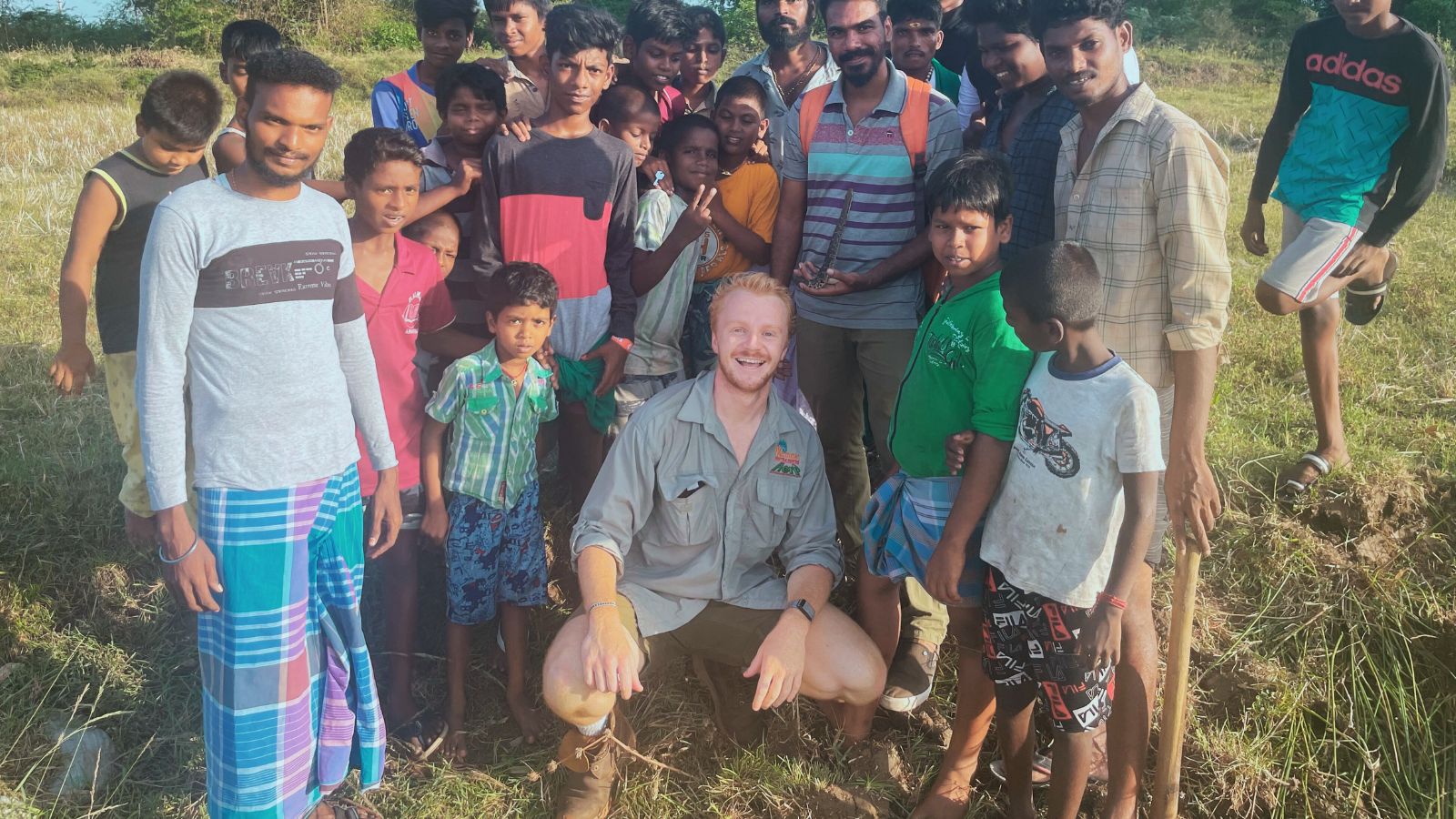 Photo of Harrison Carter and a group of local people in Tamil Nadu, India