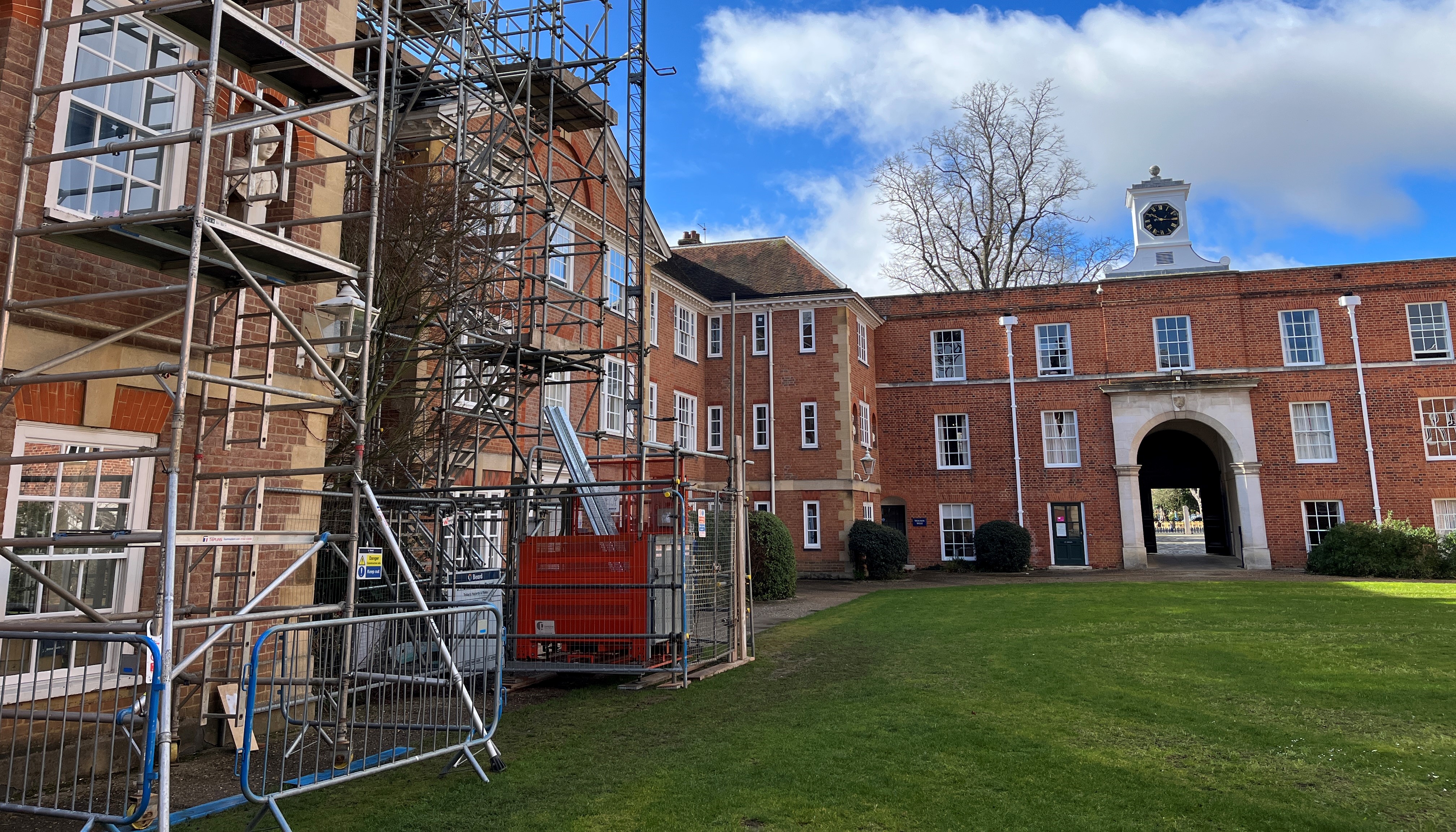 Photo of a red brick building with scaffolding