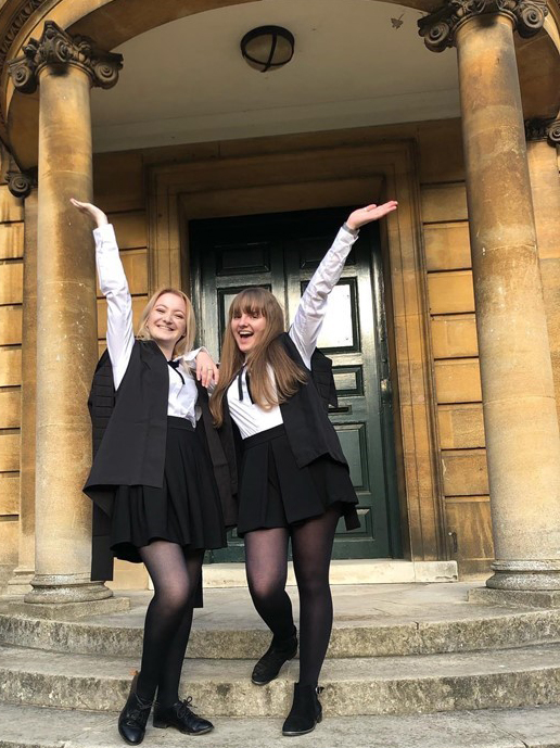 LMH student Casey Taylor celebrating in front of Talbot Hall with her friend