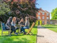 LMH students sitting at a table chatting in LMH grounds