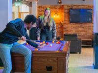 Two students playing pool in the LMH Bar