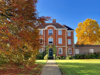 Photo by Chelsea Wallis - Pathway, orange tree, fellows lawn and a building at LMH