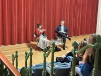 Photo of Dame Prof Marina Warner and Professor Stephen Blyth sitting on the stage in a lecture theatre