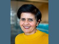 Photo of Professor Monima Chadha, who has short dark hair and is smiling at the camera