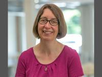 Photo of Christina Goldschmidt smiling at the camera and wearing a pink top