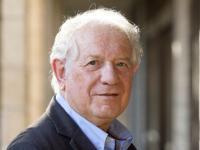 Photo of Professor Guy Stroumsa standing in front of a stone building