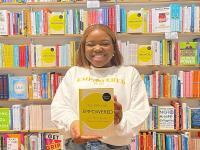 LMH alumna Vee Kativhu holding her book Empowered