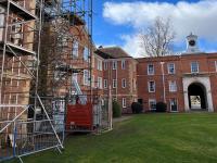 Photo of a red brick building with scaffolding