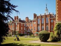 A view of LMH's Talbot Hall through the gardens