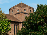 The exterior of the LMH Chapel building, with a round tower against a blue sky