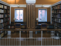 The inside of the LMH library, with shelves full of books on either side of two windows
