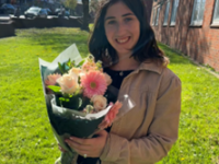 Agnes with a bouquet of flowers