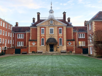 Talbot Hall, an imposing red brick building with a spire, on a frosty morning