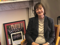 Margaret Coombe sitting on a chair in her office