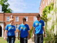 Three students wearing blue LMH T shirts