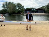 James Lindsay stood next to an Eights boat