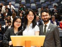 Sum Lau, Yvette Young, and Syed Adil in front of a lectern