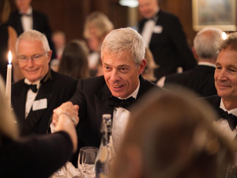 Neil Simpkins at a gaudy, conversing over the table