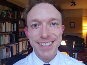 Dr Ben Higgins, who is wearing a white shirt and dark tie