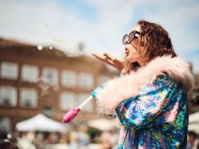 A circus performer blowing bubbles