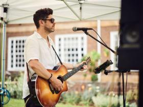 Performer playing guitar and singing