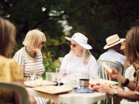 A group chatting in the gardens