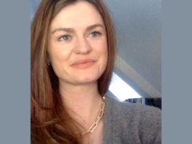 Dr Felicity Brown, who has long brown hair and is wearing a grey sweater