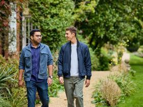 Two male students walking through the LMH gardens