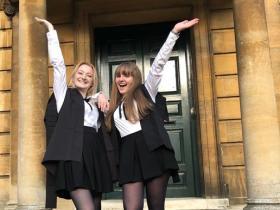 LMH student Casey Taylor celebrating in front of Talbot Hall with her friend