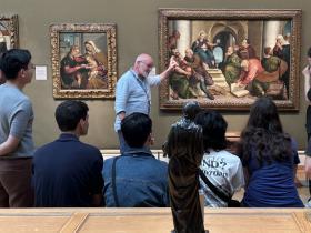 A curator presents Renaissance paintings in the Ashmolean Museum to LMH students