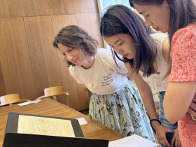 Three people looking at the handwritten letters of Jane Austen in the Bodleian Library