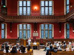 View of the interior of the Oxford Union, with LMH students leading a debate