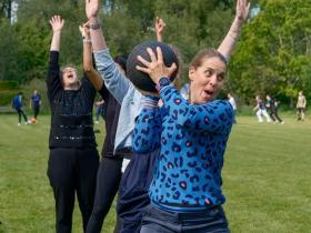 A member of staff throwing a ball in a sports day game