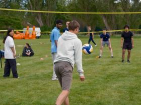 A group of people playing volleyball
