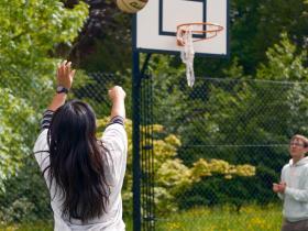 A student taking a basketball shot