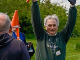 Vice-Principal Todd Huffman celebrating with a relay baton in hand
