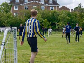 Students and staff playing football in the LMH gardens