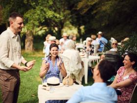 A group at a table in the MH Gardens during the LMH10 event