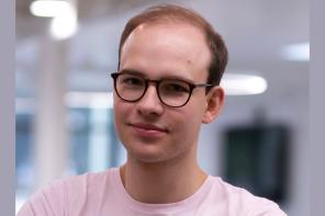 Photo of David Geldbach, who wears glasses and pink tshirt