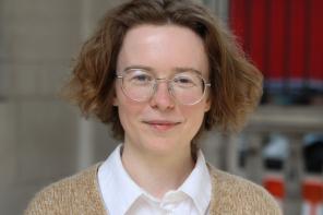 Marlene Danner, a woman with short curly hair and glasses, smiles at the camera